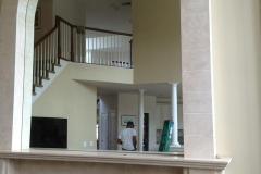 Rounded mirror over the fireplace.