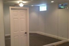 Mirrored wall enhances the appearance and perception of room size.