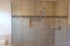 Frameless door panel with a 90 degree return panel for a bath remodel by Ryan Rehp Remodeling