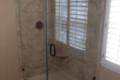 Frameless shower panel door with a 90 degree return.